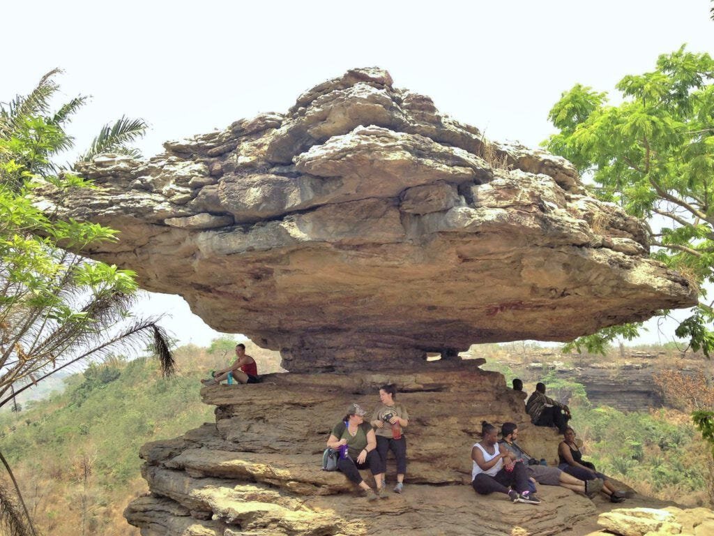 Travelers atop the Larabanga mushroom rock
